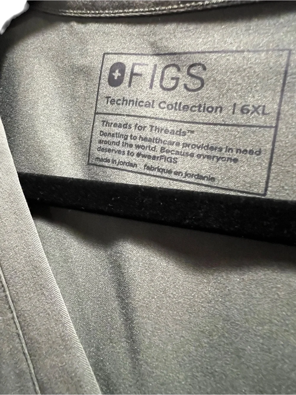 FIGS Casma three-pocket V-neck scrub top featuring a soft greyish-green.